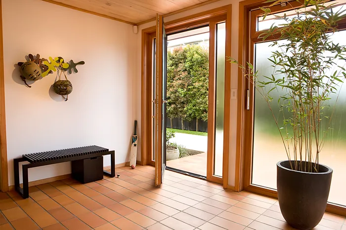 Entry with tiled floor and timber framed doors to the garden