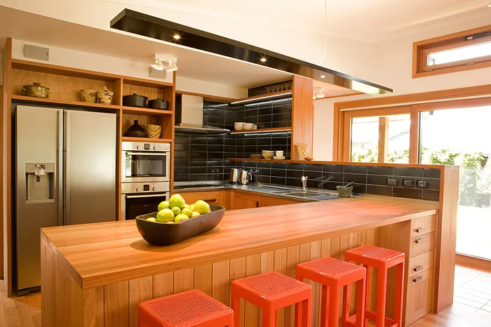 Kitchen with a timber island and timber cabinetry