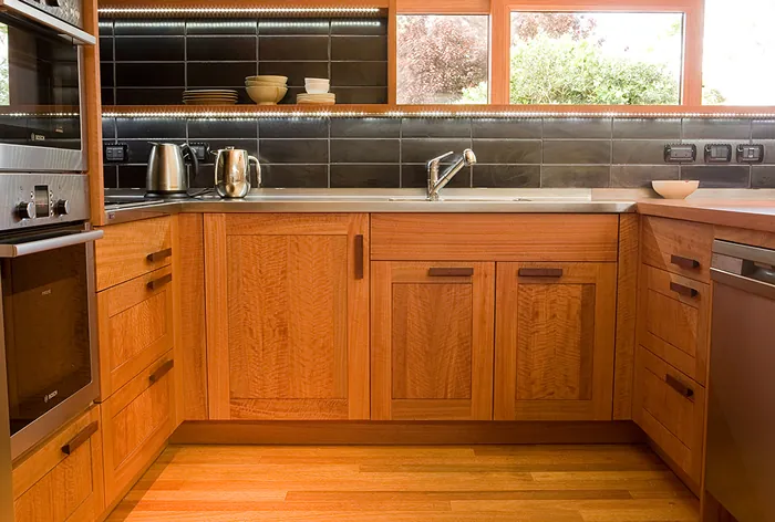 Kitchen with timber cabinetry and a tiled splashback